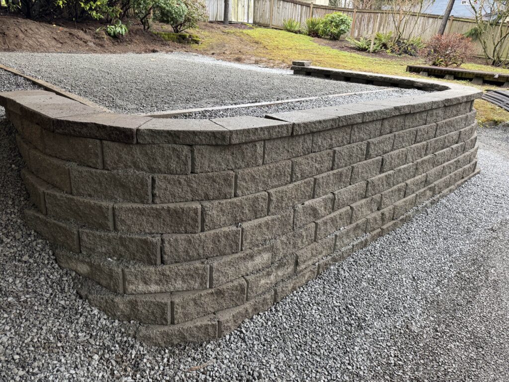 Retaining wall with fresh gravel in backyard of Woodinville home